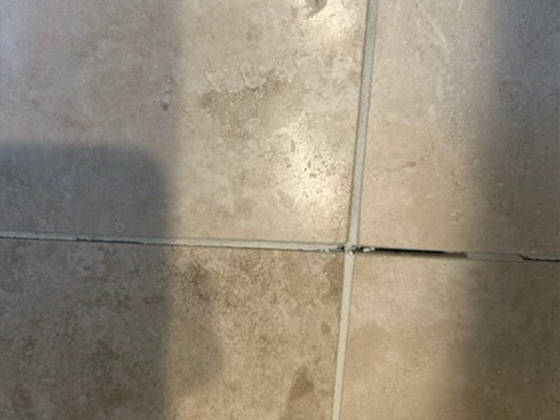 Travertine tile with damaged grout